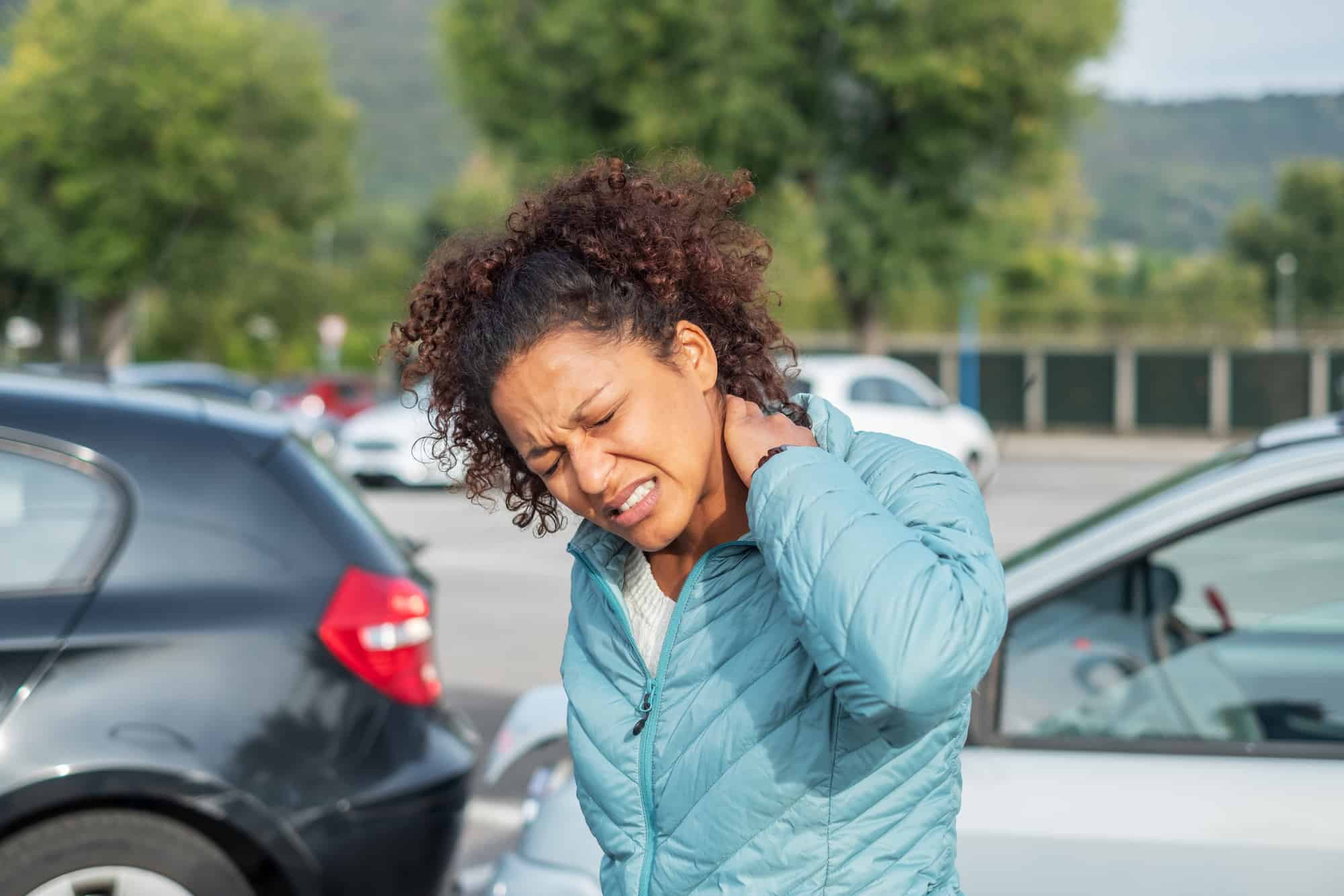 A woman painful whiplash after a fender bender car crash.