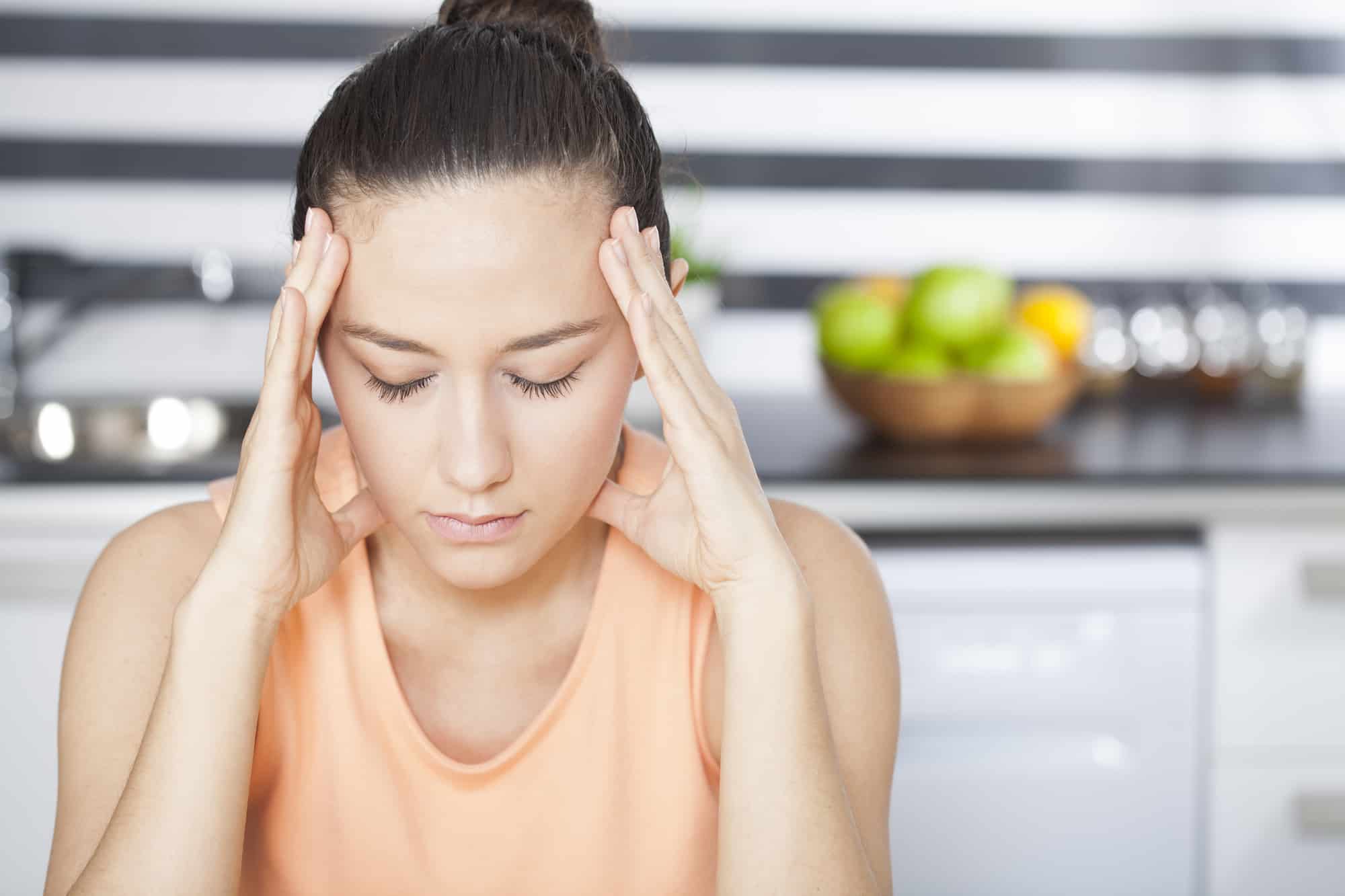 A woman is experiencing a headache