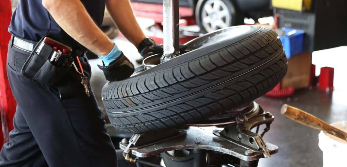 Auto Repair Mechanic Changing a Tire