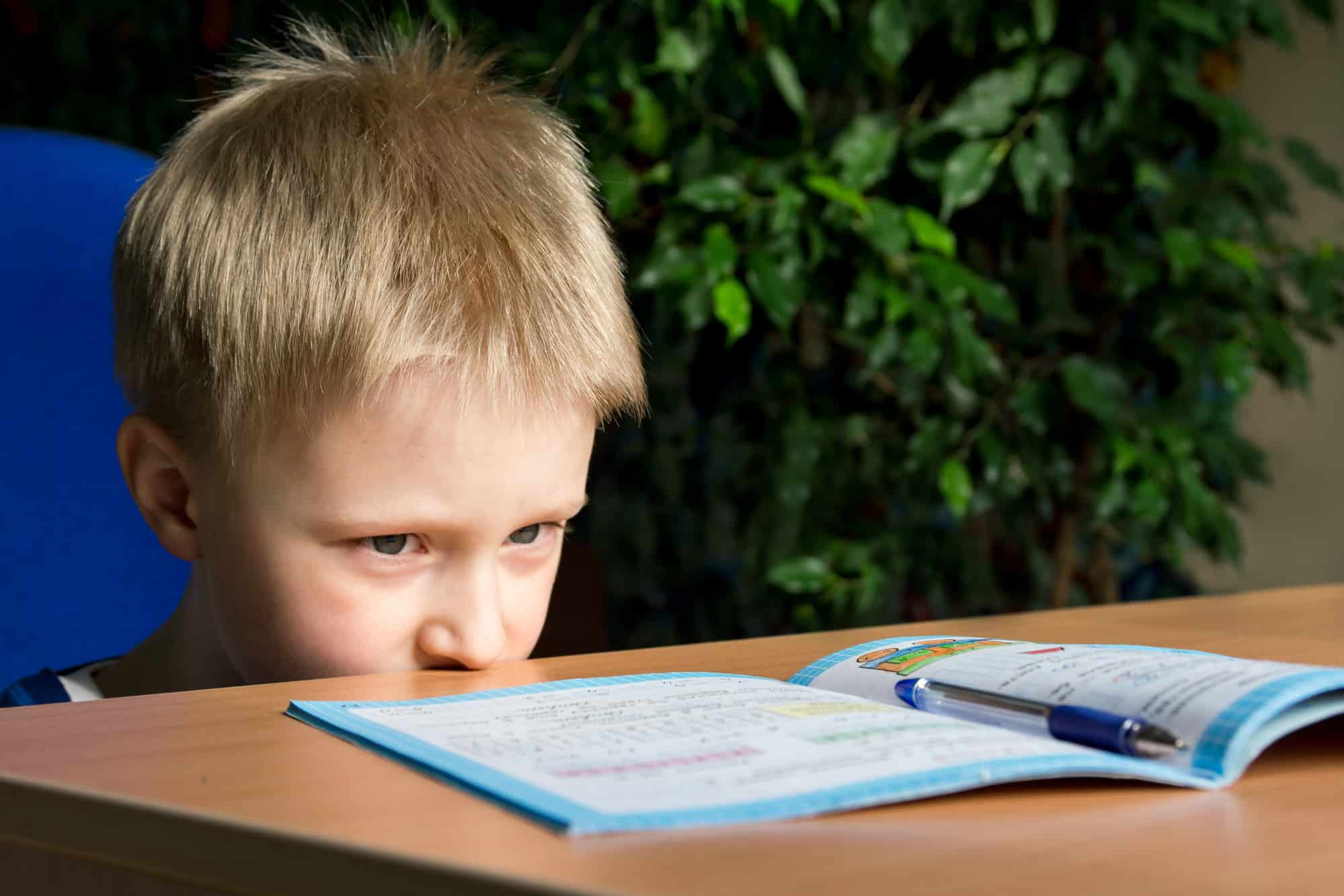 A young boy with ADHD struggling to focus on his studies