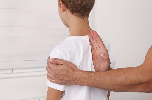 Chiropractic treatment for children, posture correction, and scoliosis examination