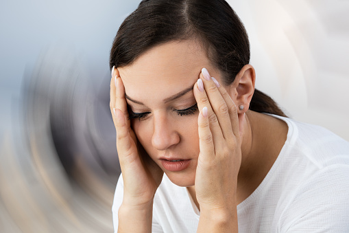 A young woman suffering from vertigo illness