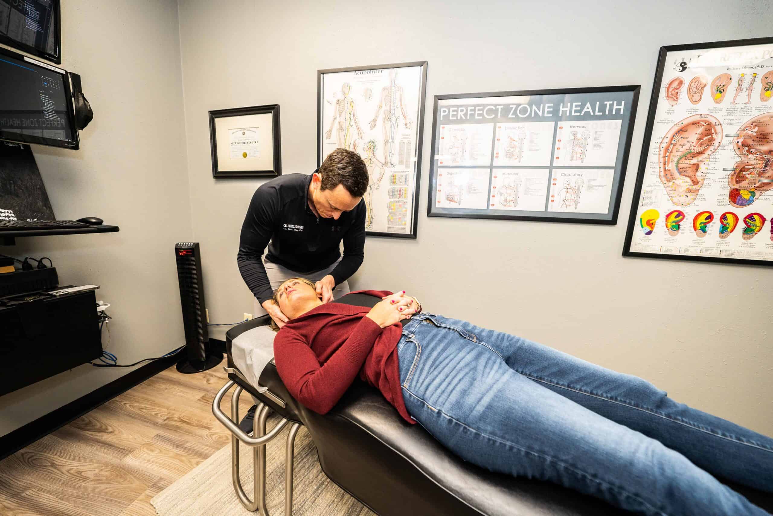 A woman is receiving her routine chiropractic care from Dr. Ring.