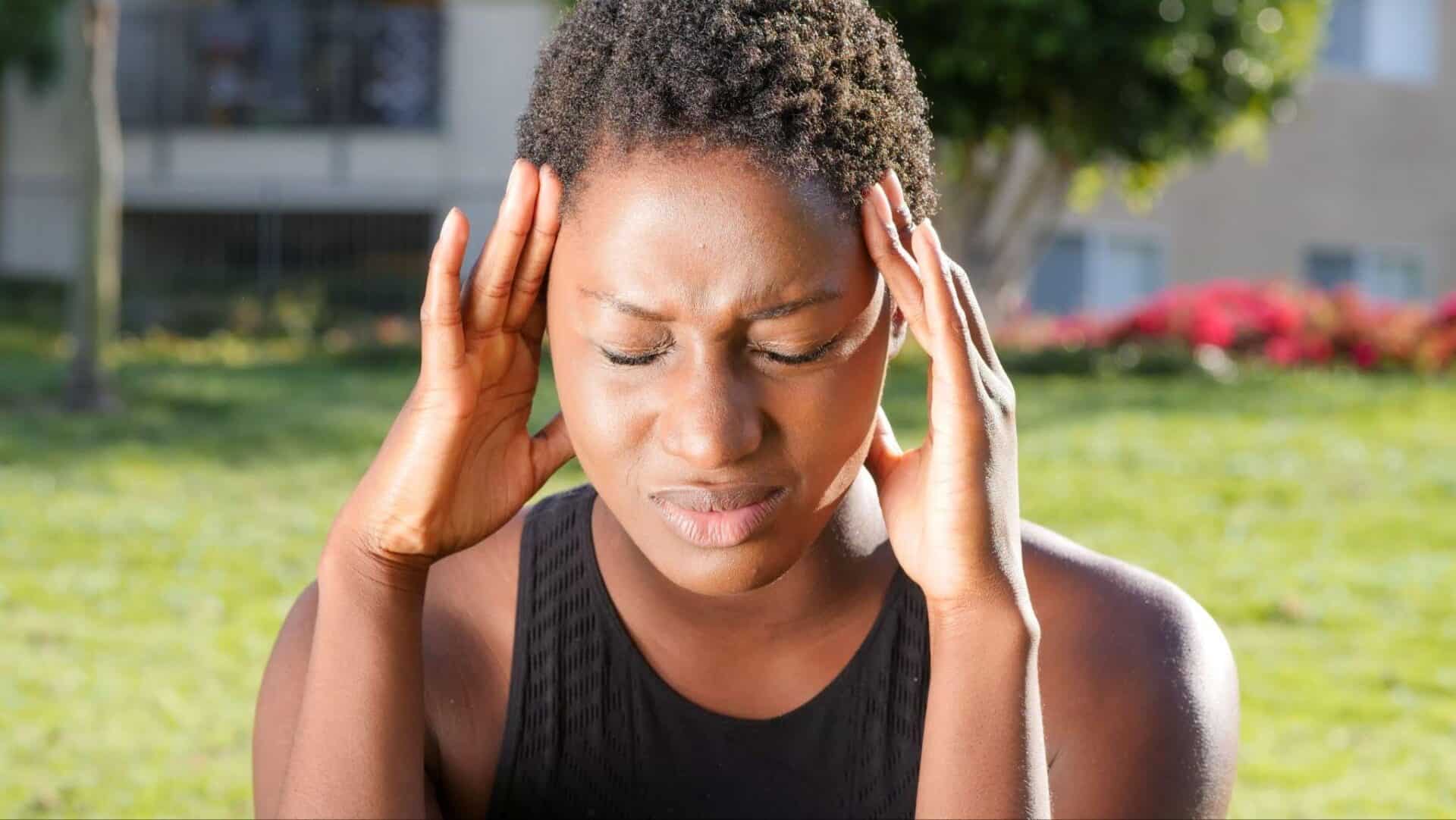 an athlete having a bad headache during her training