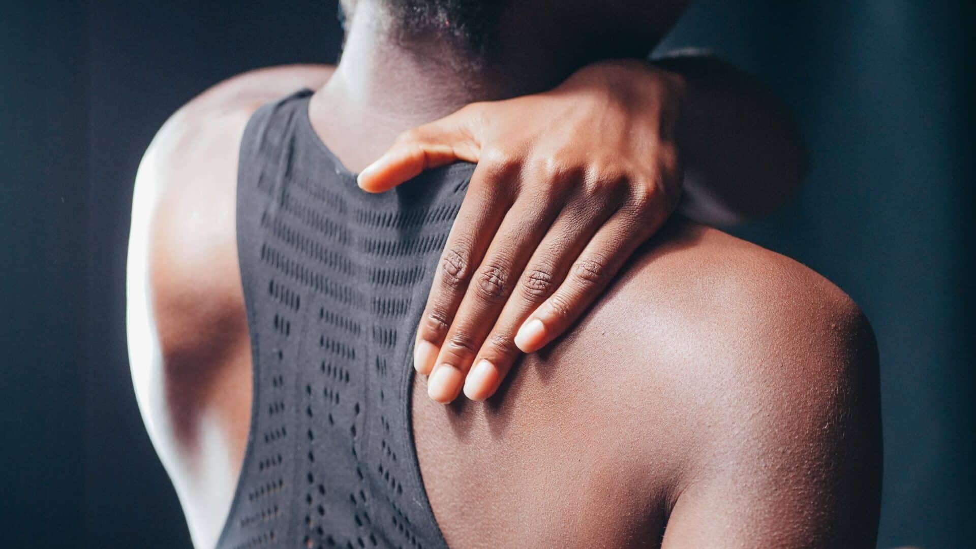 a man suffering from upper back pain